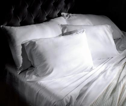 Luxury sheets in white on a bed