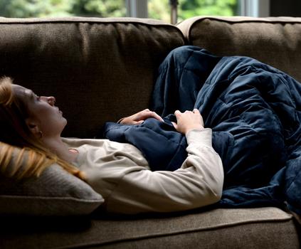 Cuddling under the cooling weighted blanket in navy
