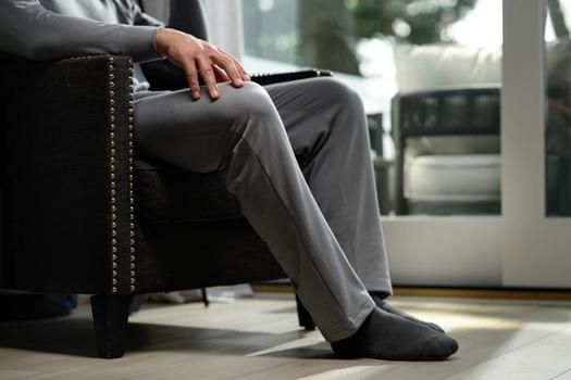 Man wearing the cozy Essential Relaxed Pant in smoke