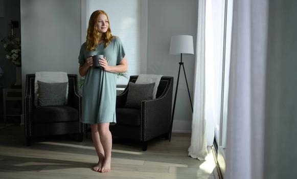Woman staying cool in Modal Pajamas in mist