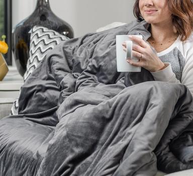 Cuddling under the cozy weighted blanket in grey