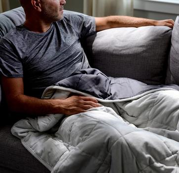 Cuddling under the cooling weighted blanket in light grey