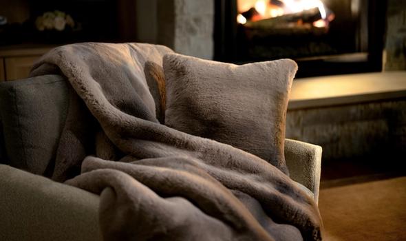 Truffle Faux Fur Pillow & Blanket by the fireplace