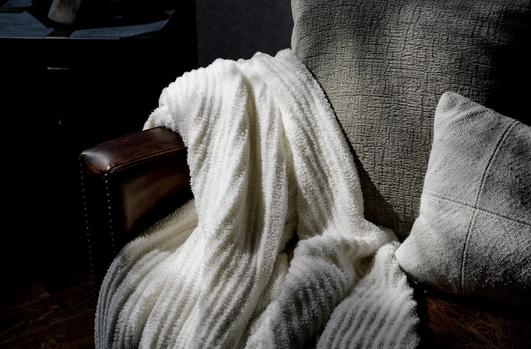 Ivory Ultra Plush Throw on a sofa
