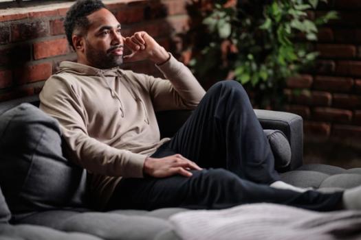 Man wearing the cozy Essential Hoodie in bone