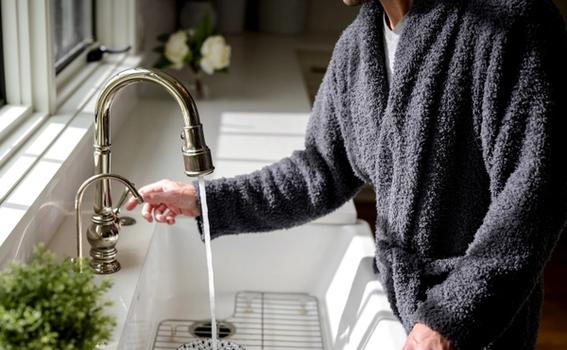 Man wearing the cozy Ultra Plush Robe in charcoal