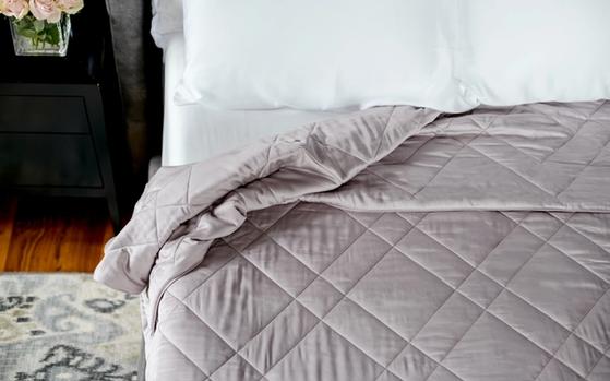 Dove bamboo blanket tucked on bed