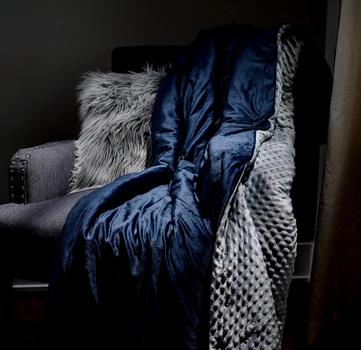 Navy grey dot weighted blanket on accent chair