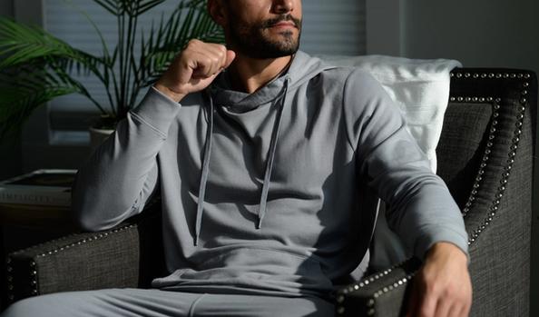 Man wearing the cozy Essential Hoodie in smoke