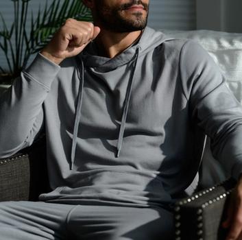 Man wearing the cozy Essential Hoodie in smoke
