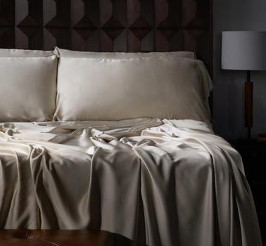 Luxury sheets in dune on a bed