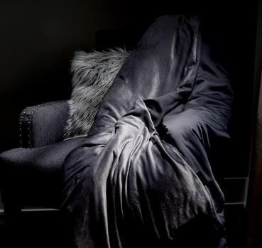 Grey weighted blanket on accent chair