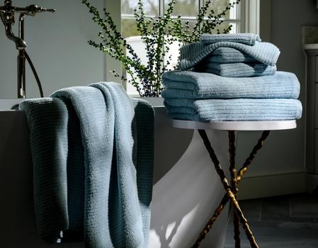 Surf Plush Performance Towels next to a bath tub