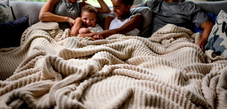 Generously sized blanket covering family comfortably