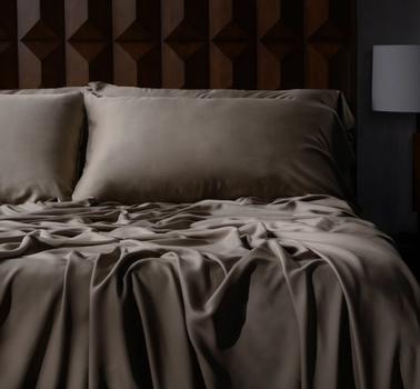 Luxury sheets in truffle on a bed