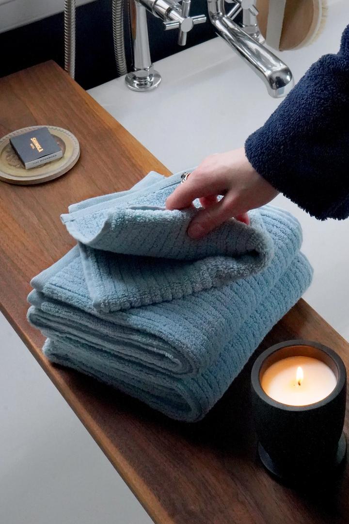 Surf towels sitting on a bath tub