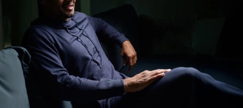 Man lounging, feeling comfy in the Essential Loungewear