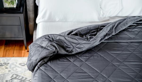 Charcoal bamboo blanket tucked on bed