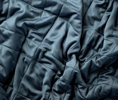 Luxury bamboo blanket, close-up detail of the fabric in the color ocean