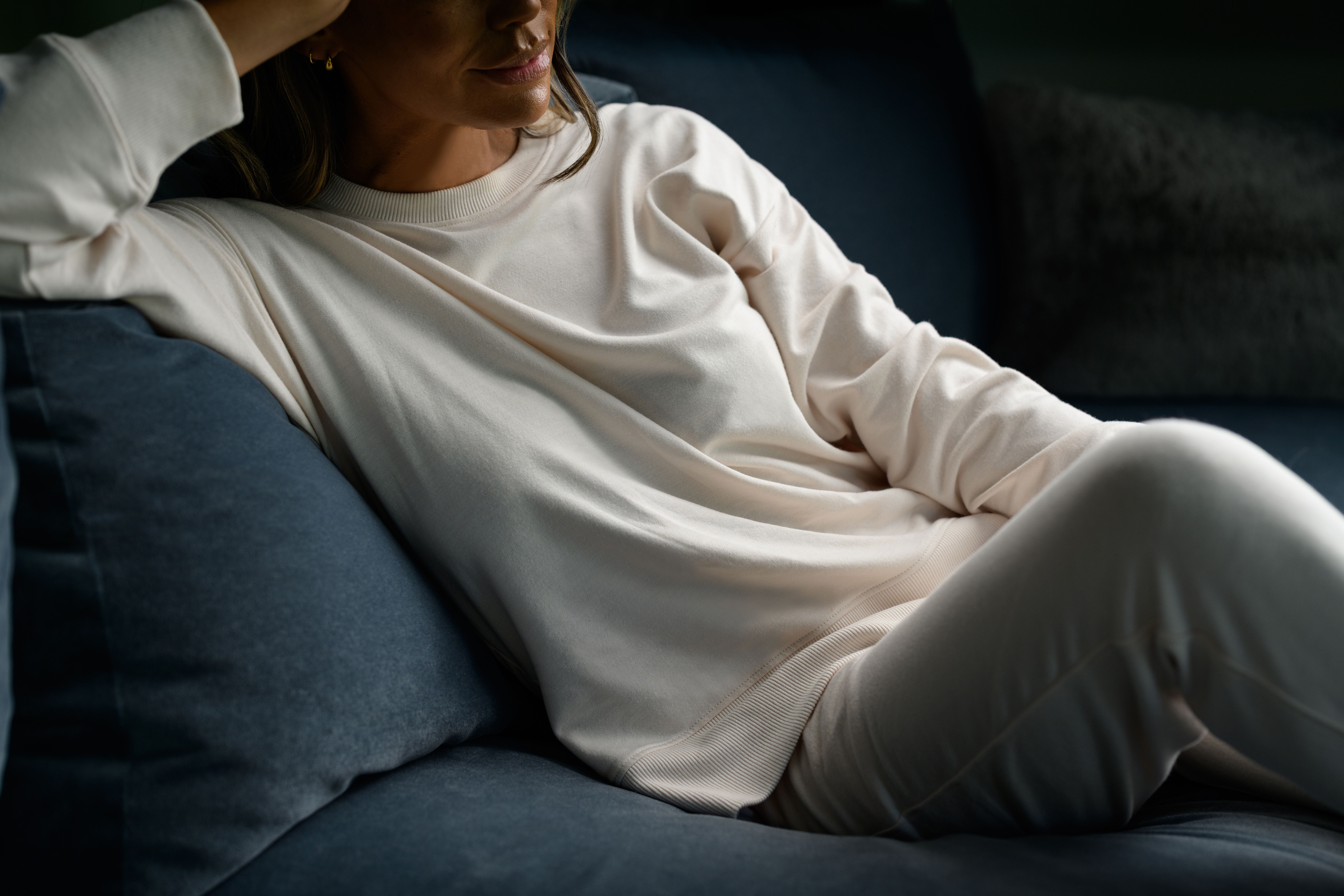 Woman wearing cozy loungewear in the color almond