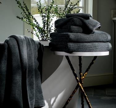 Fossil Plush Performance Towels next to a bath tub