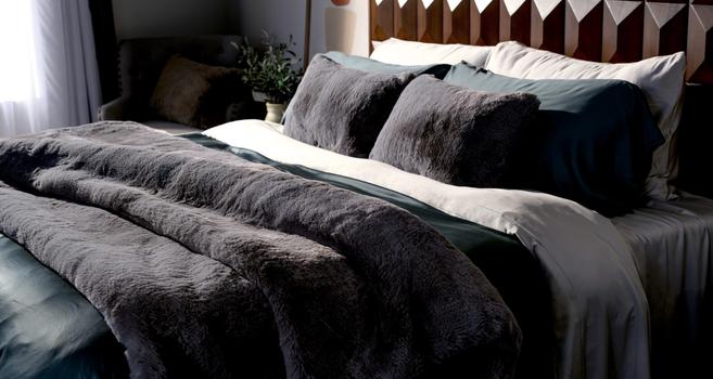 Bed made up of Fog Faux Fur Blankets & Pillow