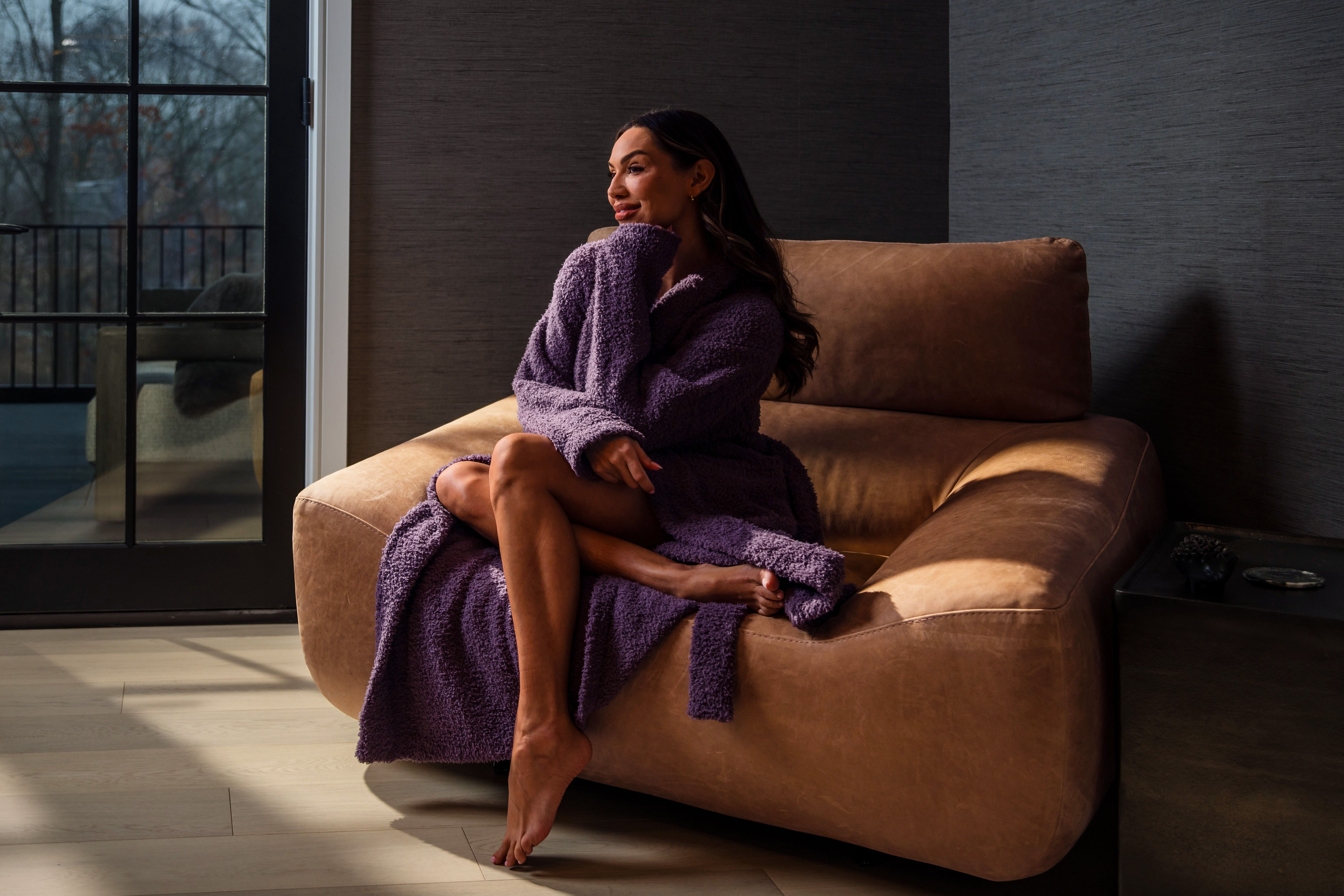 Woman snuggling in her have ultra plush robe