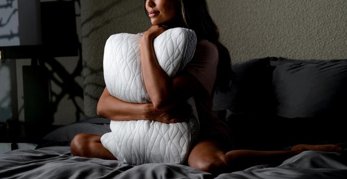 Woman hugging the Dual Chamber Pillow