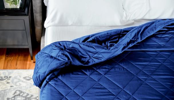 Sapphire bamboo blanket tucked on bed