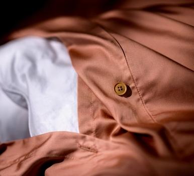 Close up of a bamboo duvet cover with extra ties in the color terracotta