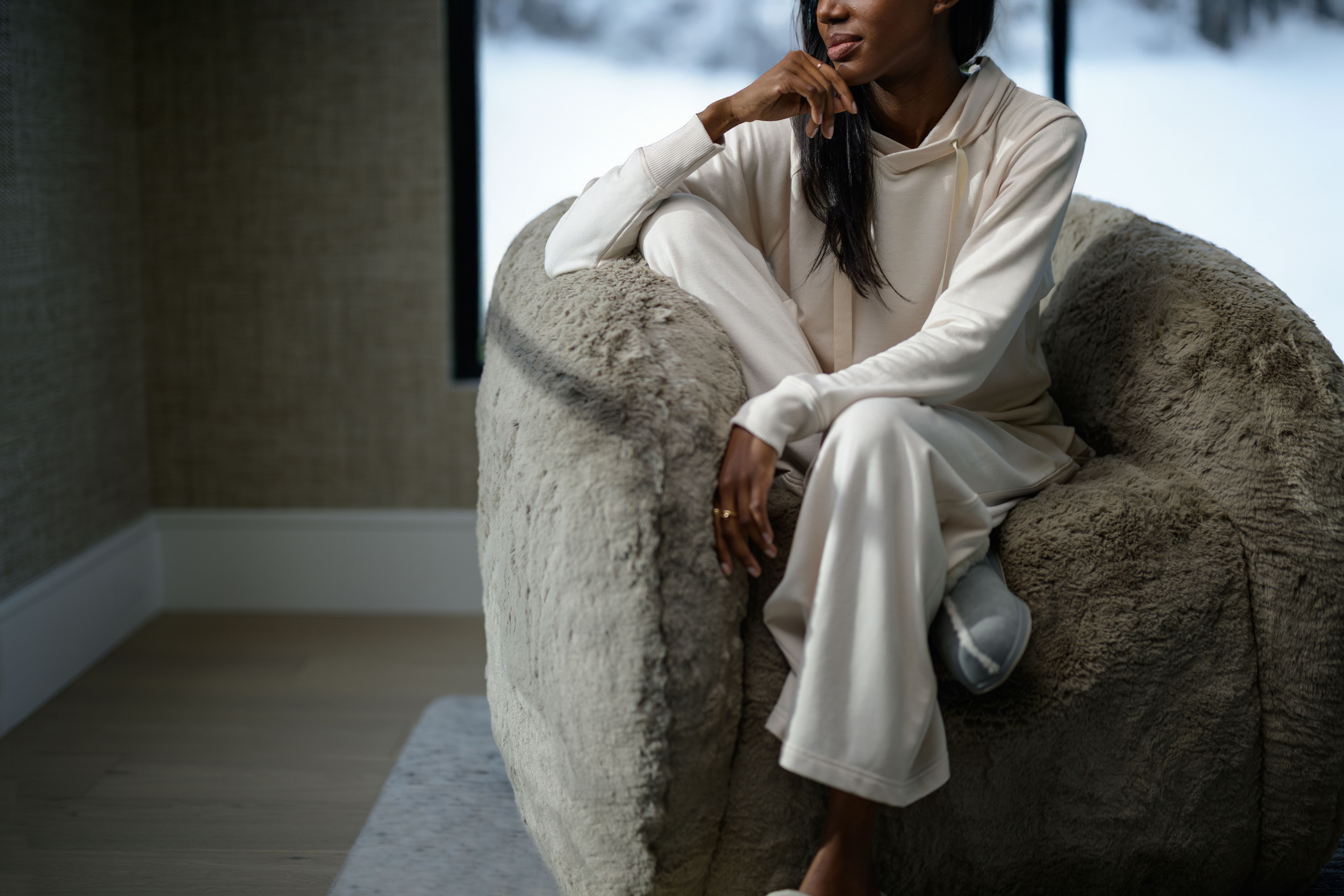 Woman wearing cozy loungewear in the color almond