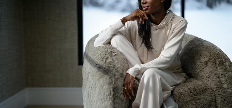Woman wearing cozy loungewear in the color almond