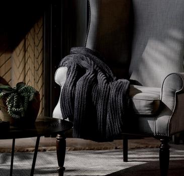 Charcoal Ultra Plush Throw on a chair