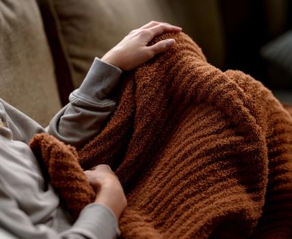 Luxome throw blanket shown in the stylish hue clay