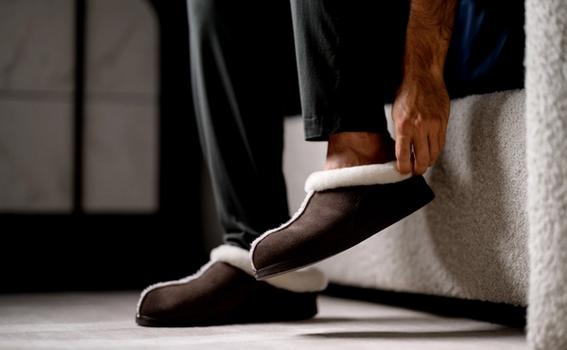 Man slipping on Walnut Signature Slipper