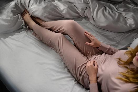 Woman staying cool in Modal Pajamas in peony
