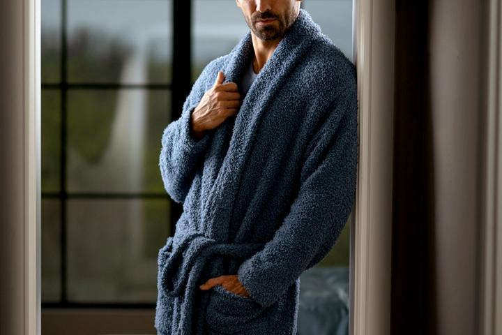 Man standing in hallway, loving his Drift Ultra Plush Robe