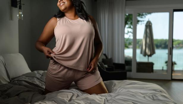 Woman staying cool in Modal Pajamas in peony
