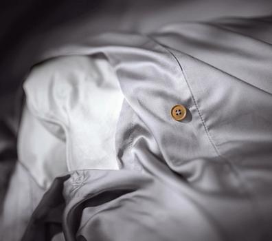 Close up of a bamboo duvet cover with extra ties in the color stone