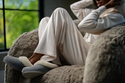 Woman wearing cozy loungewear in the color almond