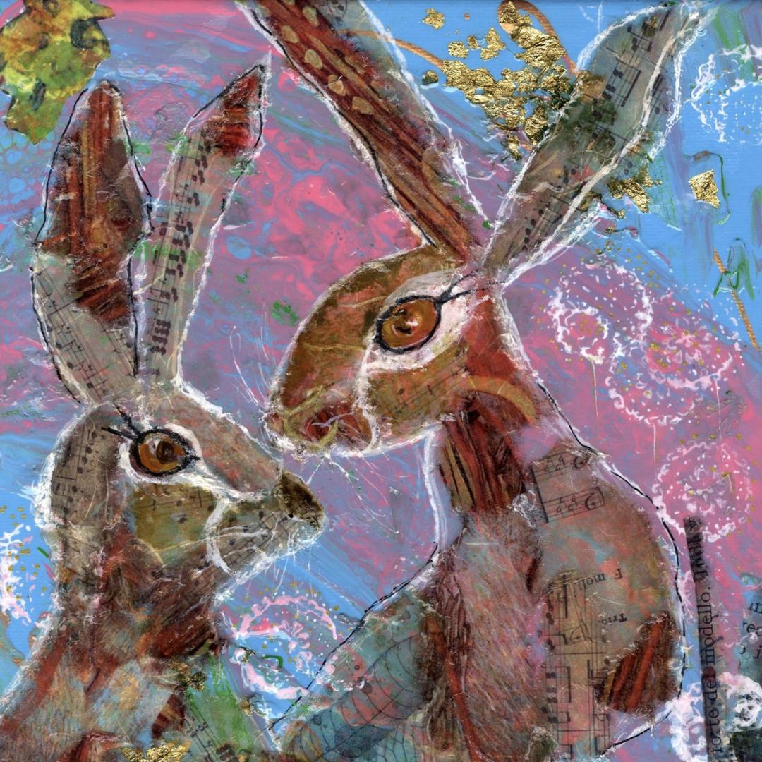Two hand-cut collage hares face each other on a vibrant pink and blue painted background, layered with expressive mark-making, resin and gold leaf