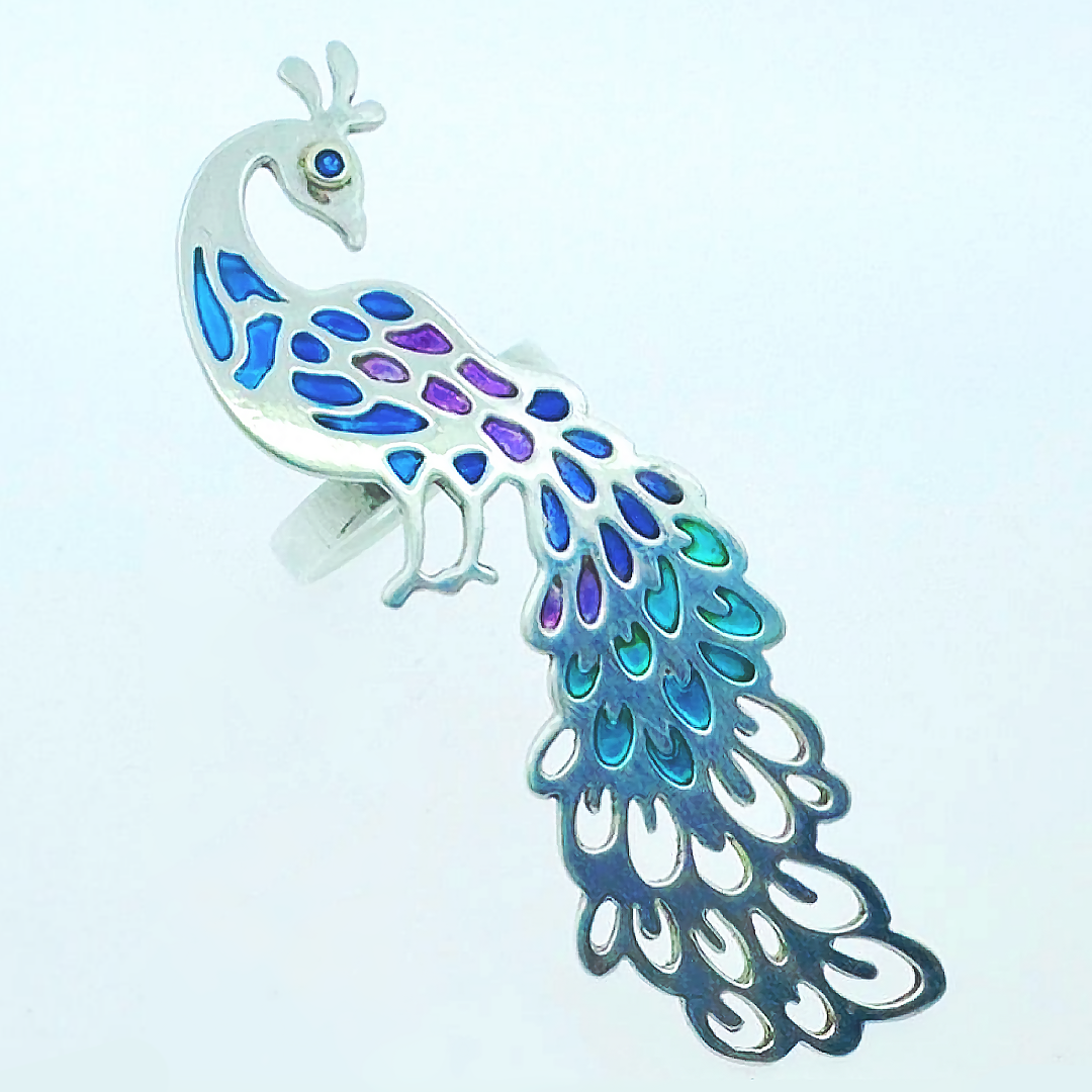 Silver peacock brooch with blue and purple enamel inlay on the body and iridescent abalone shell tail feathers.