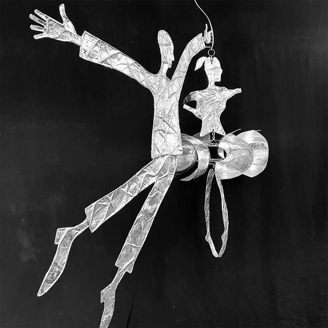 Ballerina spinning in the wind with husband directional to the winds steel wire and foil tape