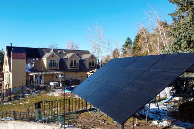 Ground-mounted solar array in a backyard