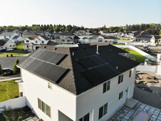 Solar on both roof faces of a two-story home in a neighborhood