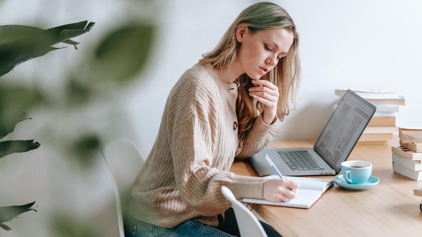 A woman sitting at a desk planning a retreat.
