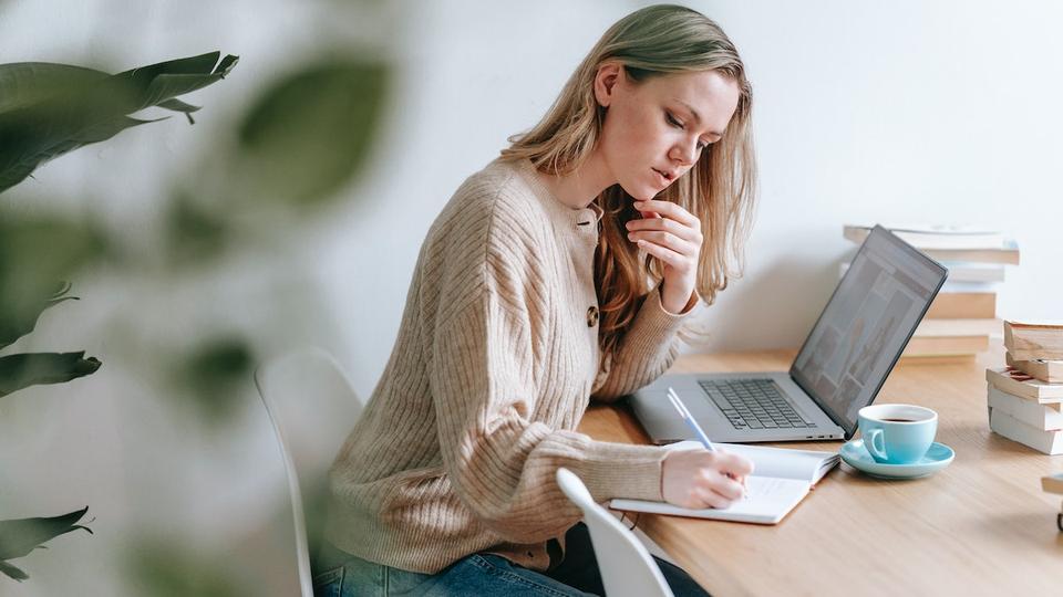 A woman sitting at a desk planning a retreat.