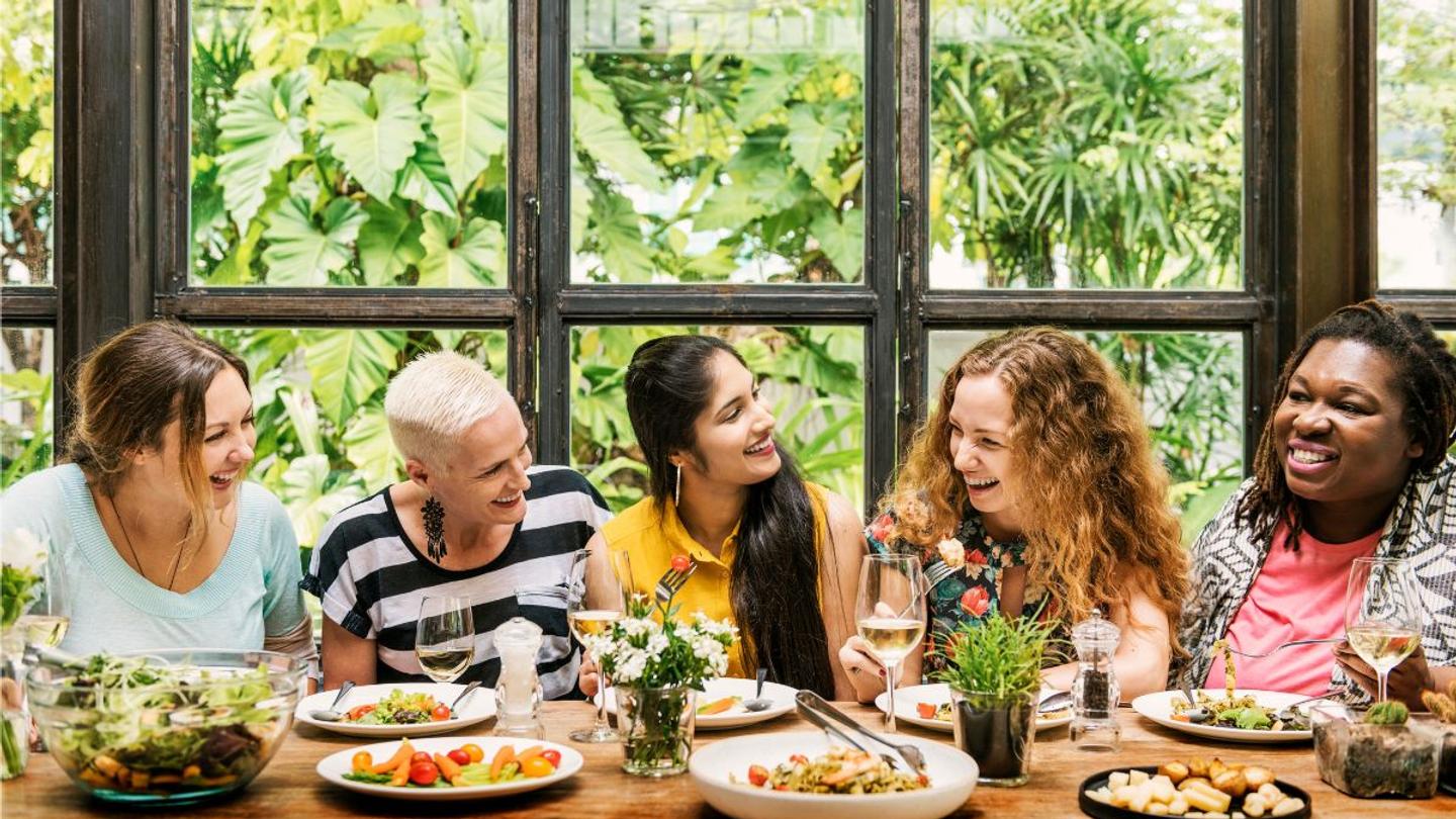 Women enjoying a meal from a well-planned retreat menu.