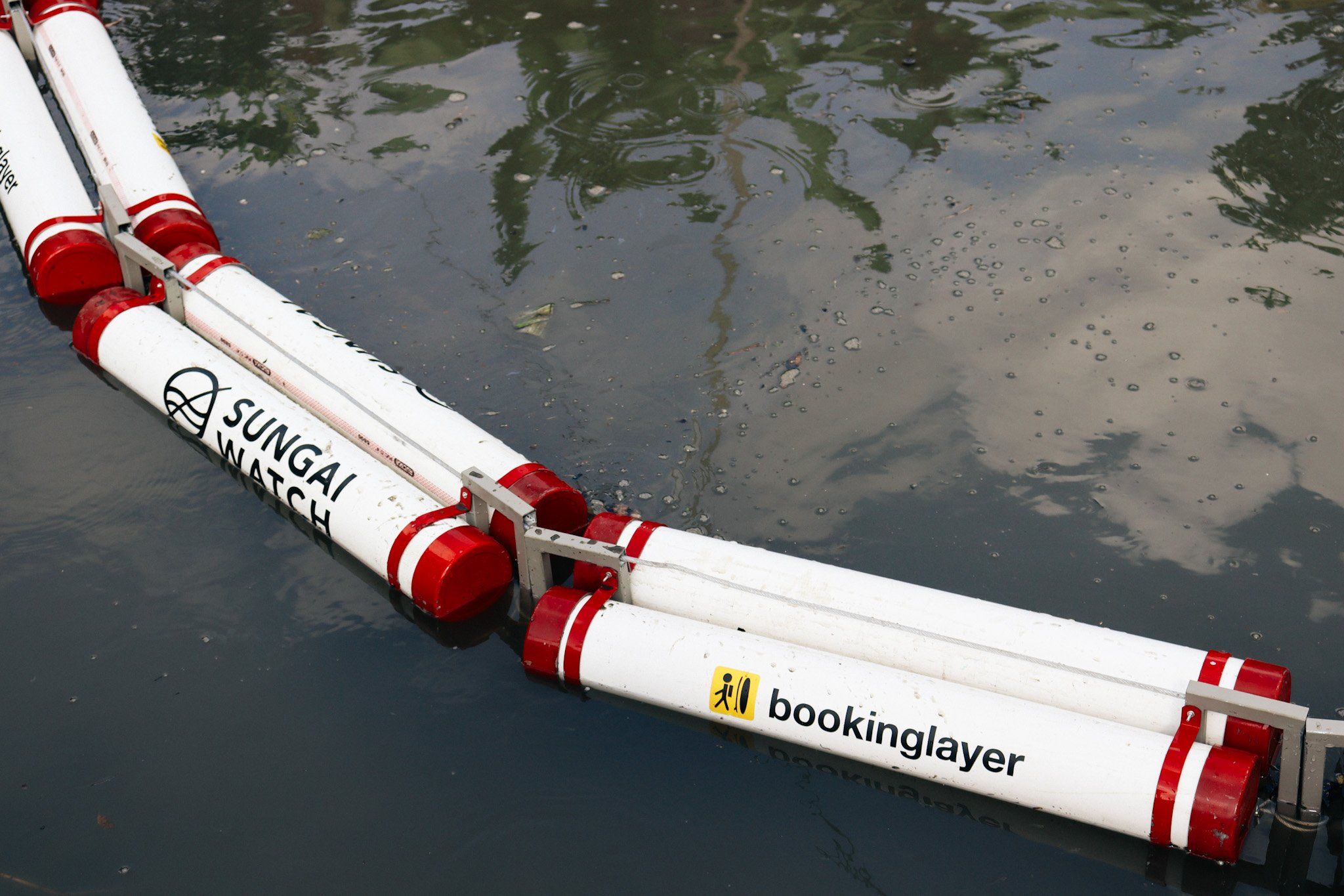 The Sungai Watch and Bookinglayer river barrier in the water.