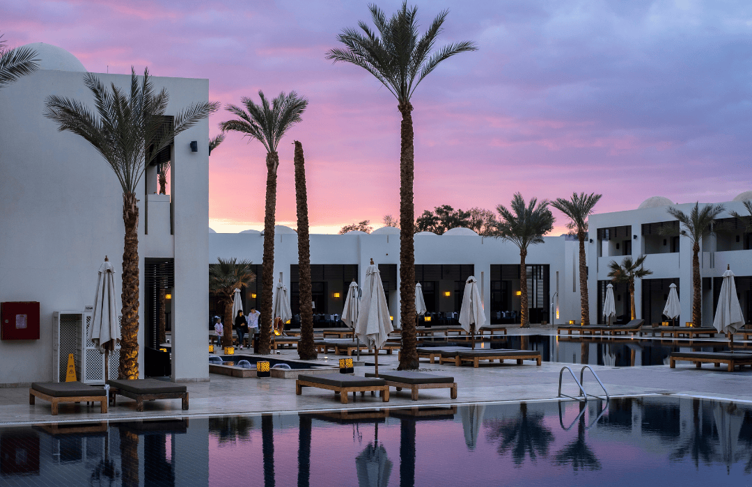 A pink sunset behind a boutique eco hotel.